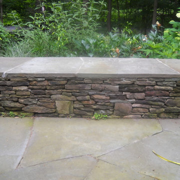 Irregular-shaped stone caps the stone wall