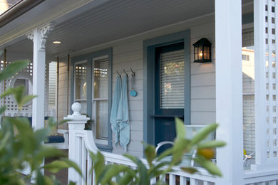 Example of a mid-sized beach style white two-story wood gable roof design in Los Angeles