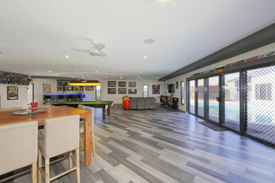 Photo of a large modern open concept living room in Sunshine Coast with grey walls and grey floor.