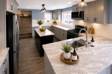 Eat-in kitchen - large farmhouse u-shaped vinyl floor and brown floor eat-in kitchen idea in Jackson with an undermount sink, shaker cabinets, gray cabinets, quartzite countertops, white backsplash, ceramic backsplash, black appliances, two islands and brown countertops