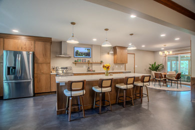 Example of a large trendy vinyl floor and gray floor eat-in kitchen design in Other with an undermount sink, shaker cabinets, medium tone wood cabinets, quartz countertops, beige backsplash, ceramic backsplash, stainless steel appliances, an island and beige countertops