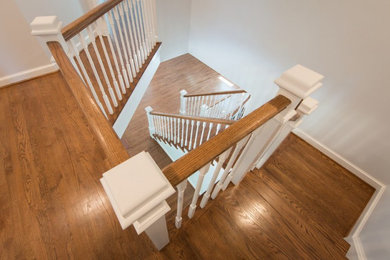 Mid-sized 1960s wooden u-shaped wood railing staircase photo in New York with wooden risers