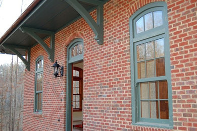 Inspiration for a mid-sized red brick exterior home remodel in Other