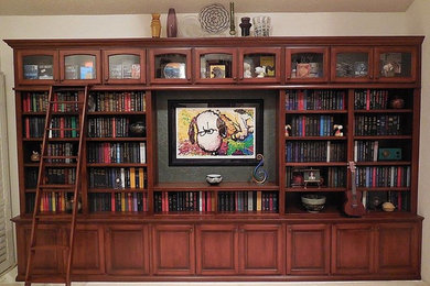 Inspiration for a large timeless carpeted family room library remodel in San Diego with yellow walls, no fireplace and no tv