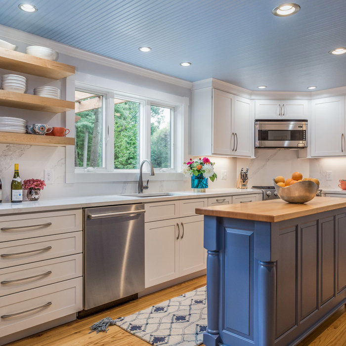 Kitchen - farmhouse l-shaped medium tone wood floor and brown floor kitchen idea in Boston with an undermount sink, recessed-panel cabinets, white cabinets, marble countertops, white backsplash, marbl