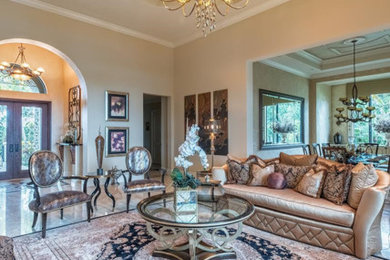 This is an example of a large mediterranean formal enclosed living room in Miami with beige walls, porcelain floors, beige floor, a standard fireplace, a concrete fireplace surround and no tv.