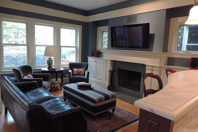 Family room - small traditional light wood floor family room idea in Chicago with blue walls, a standard fireplace and a wall-mounted tv