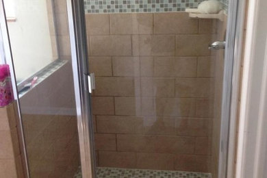 Large master multicolored tile and stone tile ceramic tile corner shower photo in Indianapolis with a drop-in sink, medium tone wood cabinets, granite countertops and beige walls
