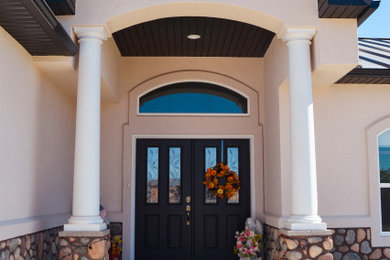 Multicolored one-story stucco exterior home idea with a metal roof