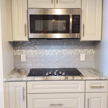 Backsplash with 3x12 textured glass and penny rounds