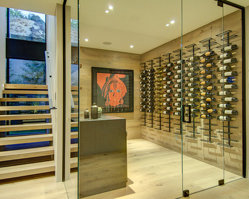 Modern Wine Cellar Phoenix Inspiration for a modern wine cellar remodel in Los Angeles with light hardwood floors and display