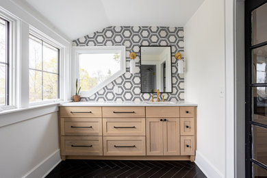 Example of a mid-sized transitional master black and white tile black floor, single-sink and vaulted ceiling alcove shower design in Columbus with shaker cabinets, light wood cabinets, white walls, an undermount sink, white countertops and a built-in vanity