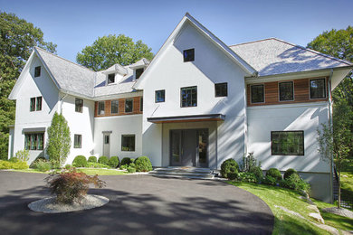 Photo of a large transitional three-storey stucco white exterior in New York.