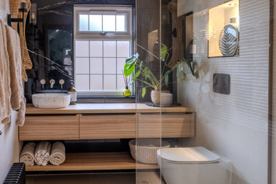 Design ideas for a small contemporary shower room bathroom in Essex with flat-panel cabinets, light wood cabinets, a walk-in shower, marble tiles, porcelain flooring, an open shower, feature lighting, a single sink, a floating vanity unit and a vaulted ceiling.