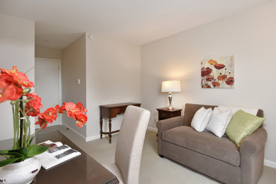 Example of a transitional home office design in Seattle