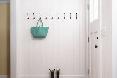 Inspiration for a large country entryway in Minneapolis with white walls, ceramic floors and grey floor.