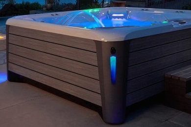 Mid-sized minimalist backyard concrete hot tub photo in Ottawa