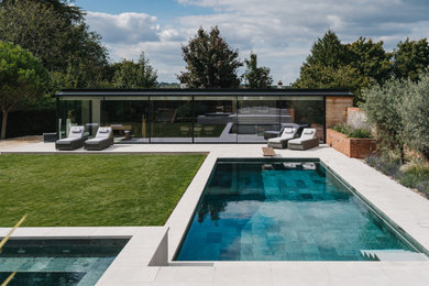 This is an example of a contemporary rectangular swimming pool in Hampshire.