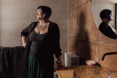 Inspiration for a small contemporary bathroom in Melbourne with green cabinets, a curbless shower, a one-piece toilet, ceramic tile, ceramic floors, with a sauna, a vessel sink, wood benchtops, a hinged shower door, a single vanity and vaulted.