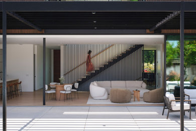 Inspiration for a large modern open concept light wood floor and brown floor living room remodel in San Francisco with no fireplace and a media wall