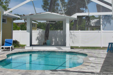 Inspiration for a small transitional side yard concrete paver pool remodel in Tampa