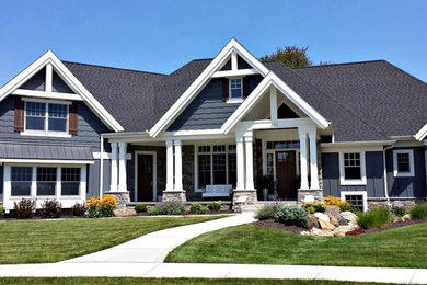 Inspiration for a mid-sized timeless gray two-story wood exterior home remodel in Other with a hip roof