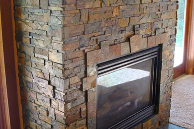 Living room - rustic living room idea in Seattle with a standard fireplace and a stone fireplace