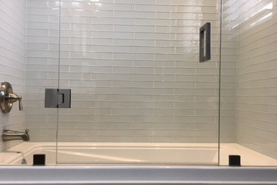 Drop-in bathtub - mid-sized transitional white tile and glass tile drop-in bathtub idea in Toronto