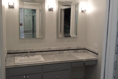 Bathroom - mid-sized transitional 3/4 bathroom idea in Richmond with recessed-panel cabinets, gray cabinets, white walls and a drop-in sink