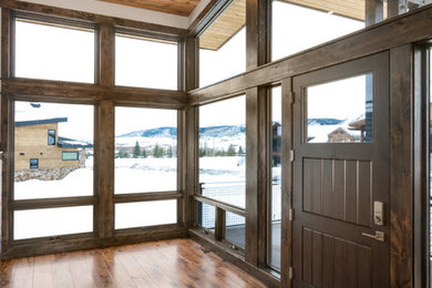 Inspiration for a mid-sized contemporary medium tone wood floor and brown floor sunroom remodel in Denver with a standard ceiling