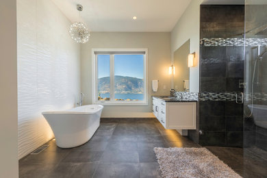 Urban master gray tile and porcelain tile porcelain tile and gray floor walk-in shower photo in Other with a hinged shower door