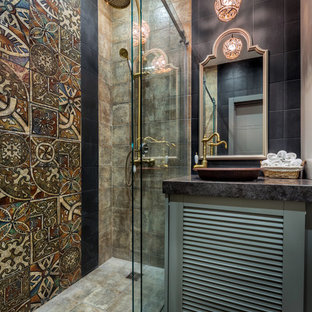 На фото: ванная комната в стиле фьюжн с фасадами с филенкой типа жалюзи, серыми фасадами, разноцветной плиткой, душевой кабиной, настольной раковиной, серым полом и черной столешницей с