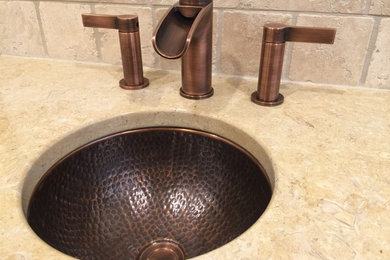 Stone tile bathroom photo in Seattle with an undermount sink and marble countertops