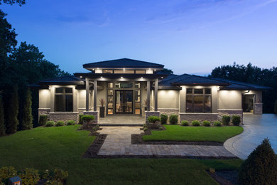 Example of a trendy gray two-story stucco exterior home design in Kansas City