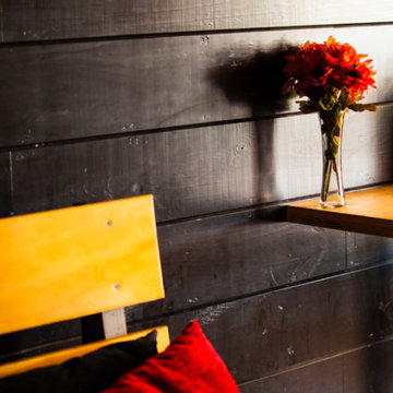 Plywood bench and black wood slat wall