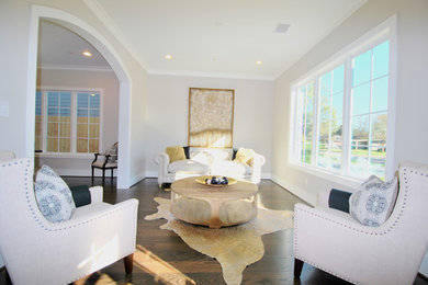 Example of a large transitional formal and open concept dark wood floor living room design in Houston with gray walls