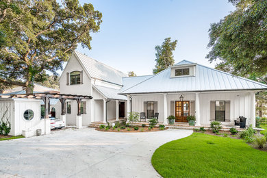 Large white two-story house exterior idea in Other with a hip roof