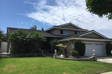 Inspiration for a mid-sized timeless beige two-story mixed siding exterior home remodel in Los Angeles with a tile roof