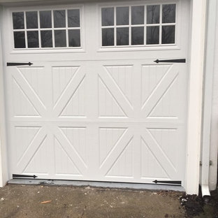 Mid-sized minimalist attached three-car garage photo in New York