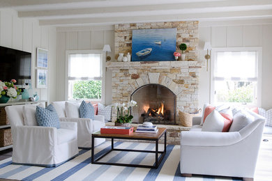 Mid-sized beach style enclosed family room photo in San Francisco with beige walls, a standard fireplace and a stone fireplace