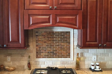 Elegant kitchen photo in Other with raised-panel cabinets and granite countertops