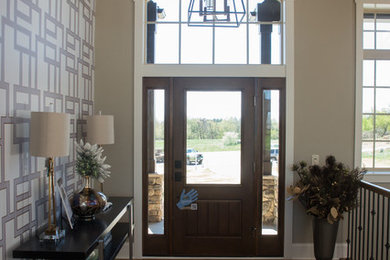 Example of a trendy medium tone wood floor single front door design in Cleveland with gray walls and a dark wood front door