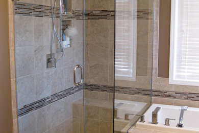 Example of a classic beige tile and ceramic tile ceramic tile drop-in bathtub design in Other with an undermount sink, raised-panel cabinets, dark wood cabinets and quartz countertops