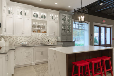 Mid-sized elegant l-shaped concrete floor and multicolored floor eat-in kitchen photo in Philadelphia with an undermount sink, flat-panel cabinets, white cabinets, solid surface countertops, multicolored backsplash, ceramic backsplash, stainless steel appliances, an island and gray countertops