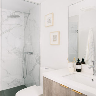 Imagen de cuarto de baño con ducha y a medida, moderno, pequeño, con armarios con paneles lisos, puertas de armario de madera clara, ducha empotrada, sanitario de una pieza, baldosas y/o azulejos multicolor, baldosas y/o azulejos de porcelana, paredes blancas, suelo de baldosas de porcelana, lavabo bajoencimera, encimera de cuarzo compacto, suelo gris, ducha con puerta con bisagras y encimeras blancas