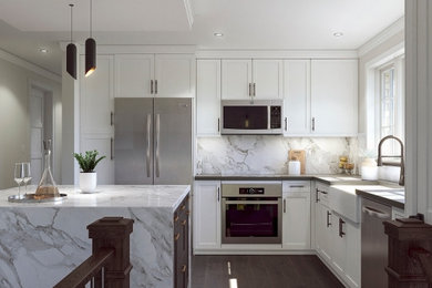 Kitchen - mid-sized contemporary dark wood floor and brown floor kitchen idea in Toronto with a farmhouse sink, shaker cabinets, white cabinets, marble countertops, white backsplash, marble backsplash, stainless steel appliances, an island and white countertops