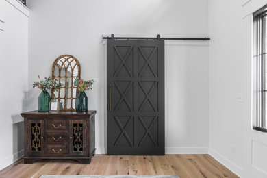 Entryway - cottage light wood floor entryway idea in Indianapolis with white walls