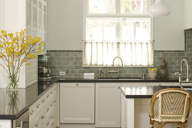 This is an example of a traditional kitchen in Los Angeles with an undermount sink, recessed-panel cabinets, white cabinets, quartz benchtops, grey splashback and subway tile splashback.