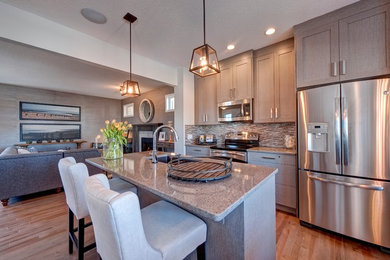 Mid-sized trendy light wood floor kitchen photo in Calgary with a double-bowl sink, stainless steel appliances and an island