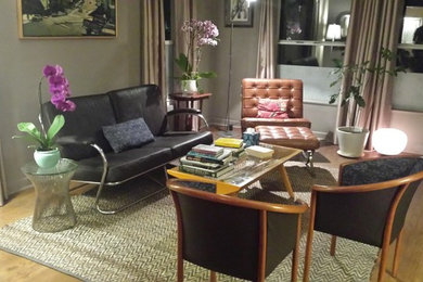 Example of a mid-sized 1950s formal and open concept medium tone wood floor and brown floor living room design in Los Angeles with gray walls, no fireplace and no tv